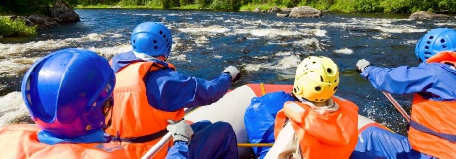 Whitewater rafters in a boat on a mountain river.