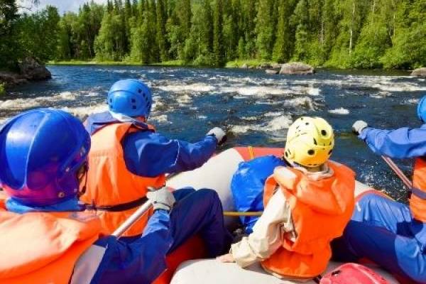 Whitewater rafters in a boat on a mountain river.