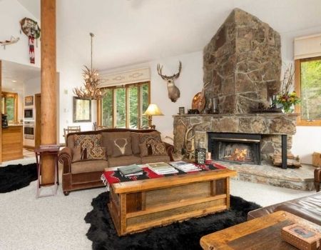 Mountain home living room with western decor and fireplace.